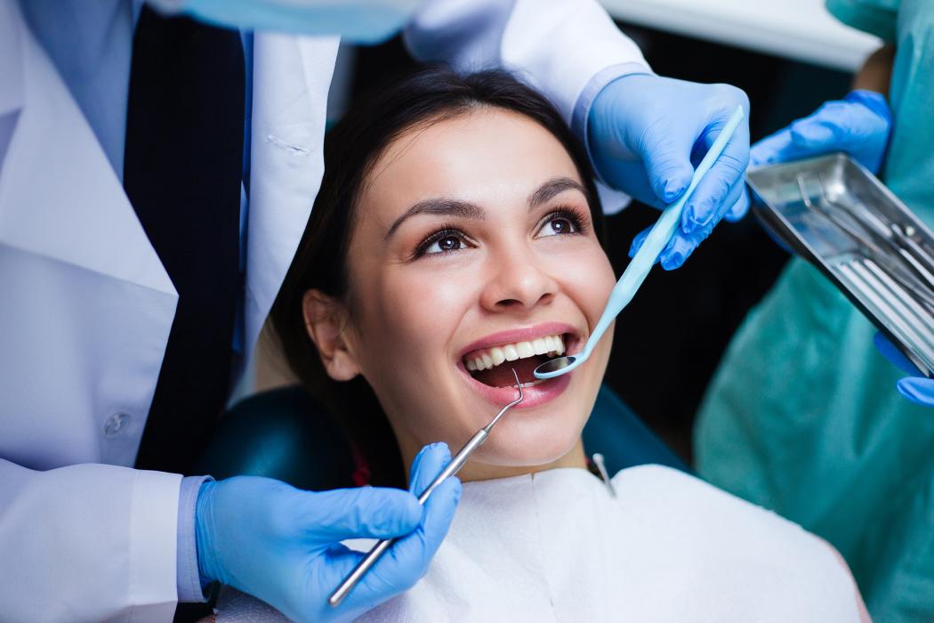 A Perfect Smile! A dentist examining his beautiful patient in the dental office.
