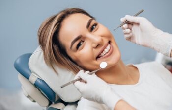 portrait of young caucasian woman with perfect smile in dental office