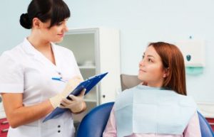 Female Dentist Consulting With Teen Girl Patient Alexandria VA
