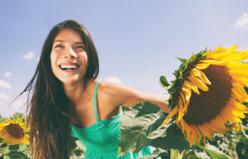 happy woman in a sunflower field