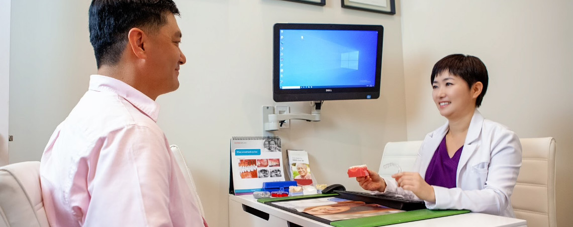 Green Dental Alexandria dentist discussing discount dental plan with a patient